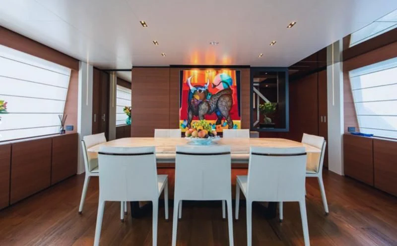 a room with a table and chairs aboard SOUTH Yacht for Sale