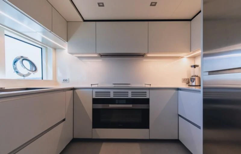 a kitchen with white cabinets aboard SOUTH Yacht for Sale