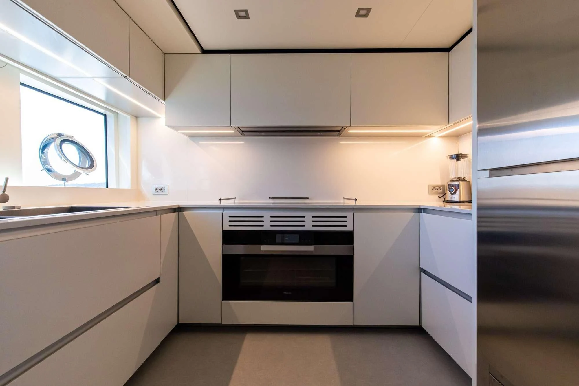 a kitchen with white cabinets aboard SOUTH Yacht for Sale