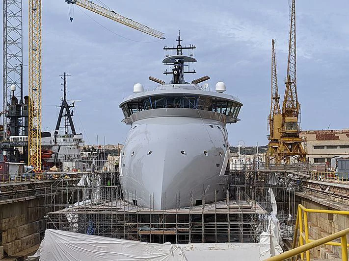 a large white ship in a harbor aboard OLIVIA O Yacht for Sale