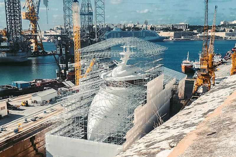 a large white ship in a harbor aboard OLIVIA O Yacht for Sale