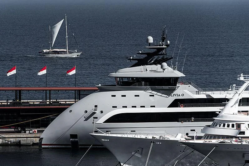 a large white yacht with a flag on top aboard OLIVIA O Yacht for Sale