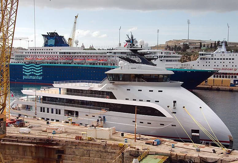 a large cruise ship docked aboard OLIVIA O Yacht for Sale