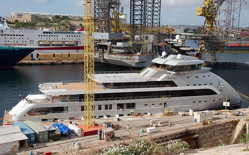 a large ship in a harbor aboard OLIVIA O Yacht for Sale