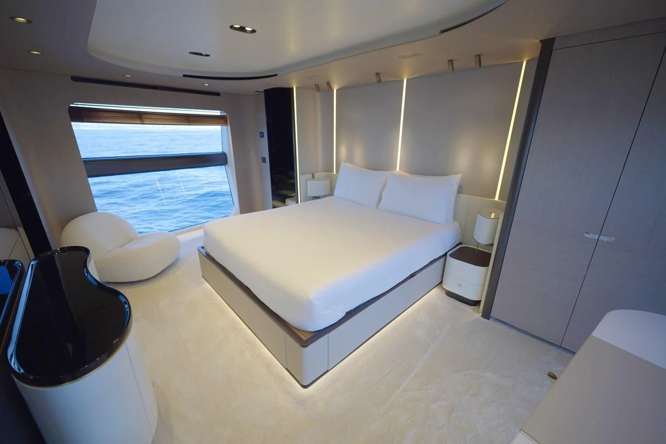 a room with a bed and a chair aboard GRANDE 27M Yacht for Sale