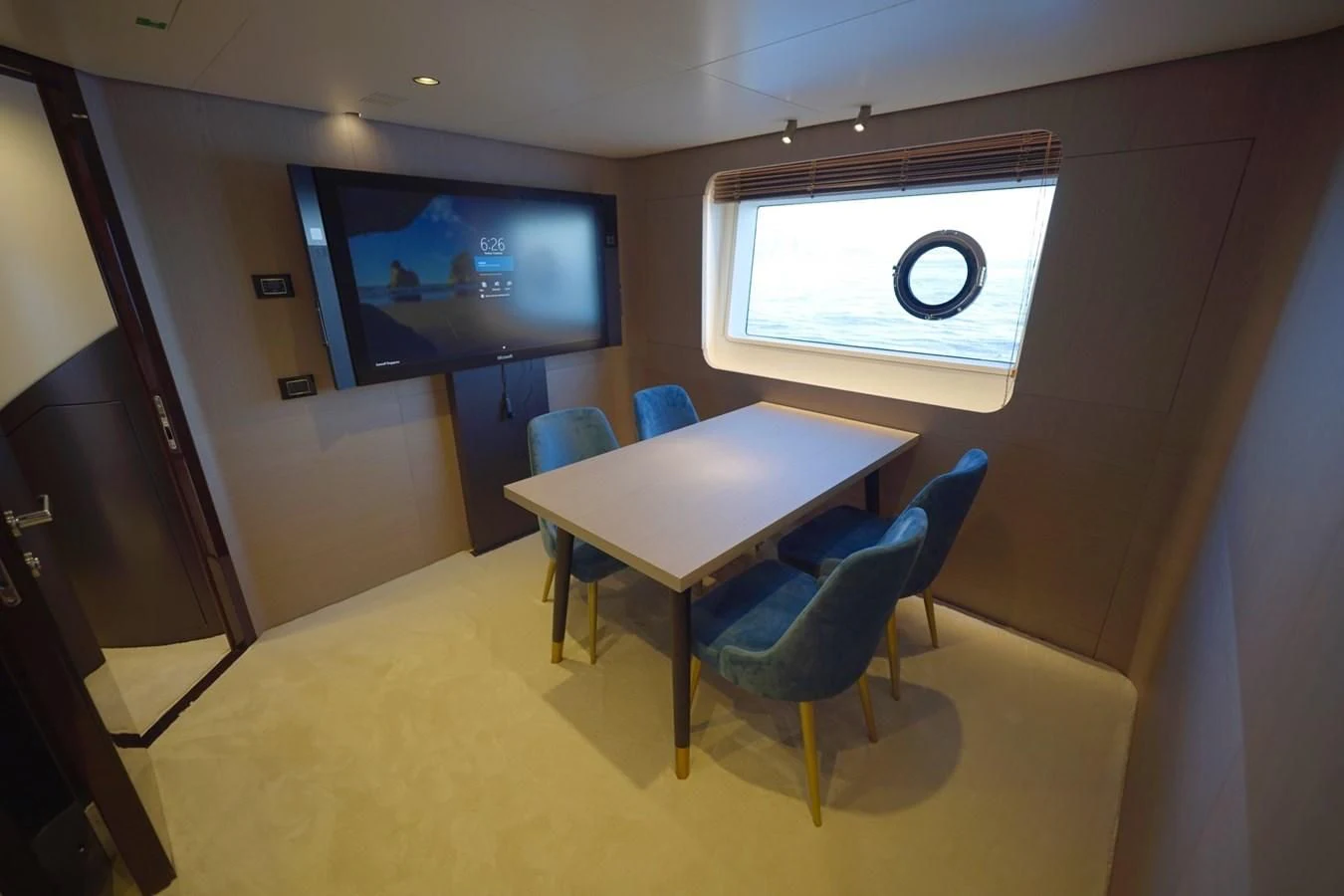 a conference room with a table and chairs aboard GRANDE 27M Yacht for Sale