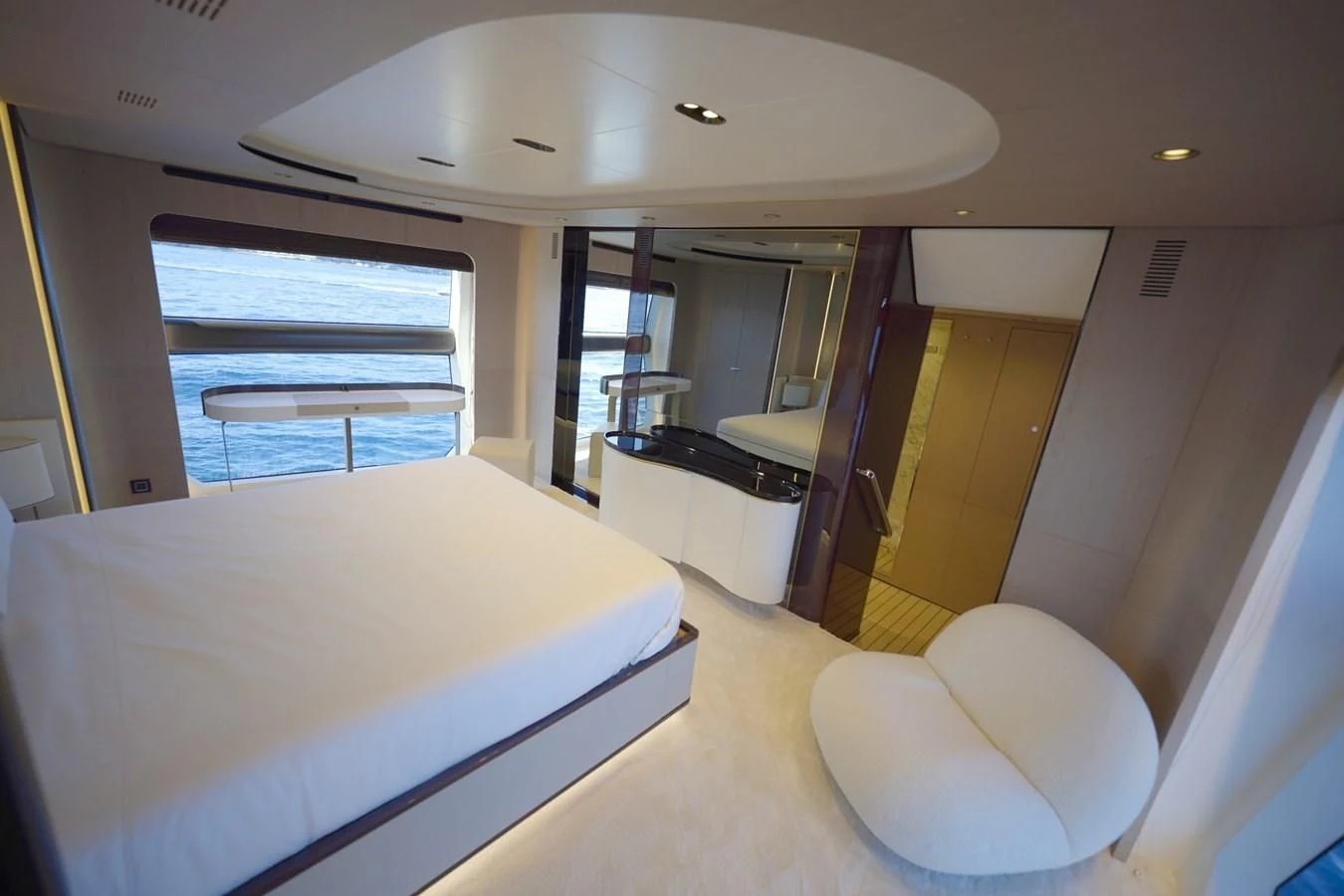 a room with a bed and a window aboard GRANDE 27M Yacht for Sale
