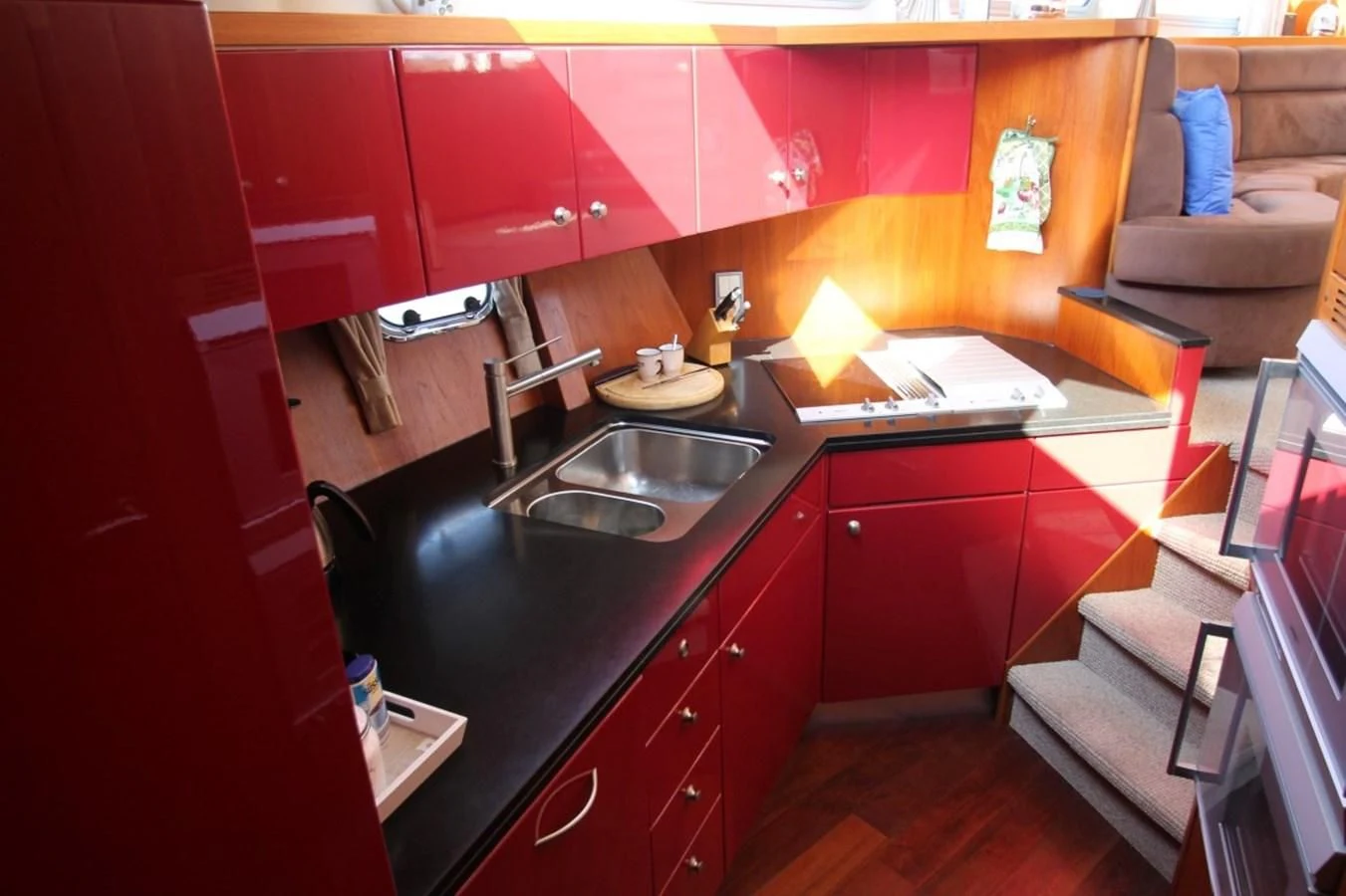 a kitchen with red cabinets aboard ELISABETH Yacht for Sale
