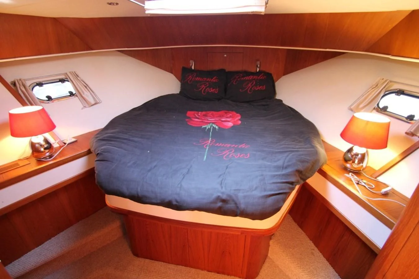 a bed with a blue blanket aboard ELISABETH Yacht for Sale