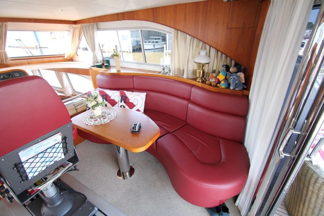a living room with a red couch aboard ELISABETH Yacht for Sale