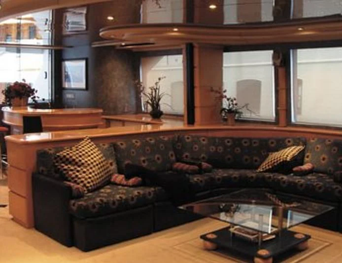 a living room with a leather couch aboard ESTANCIA Yacht for Sale