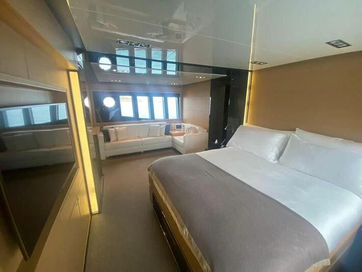 a room with a bed and a window aboard MY PLACE Yacht for Sale