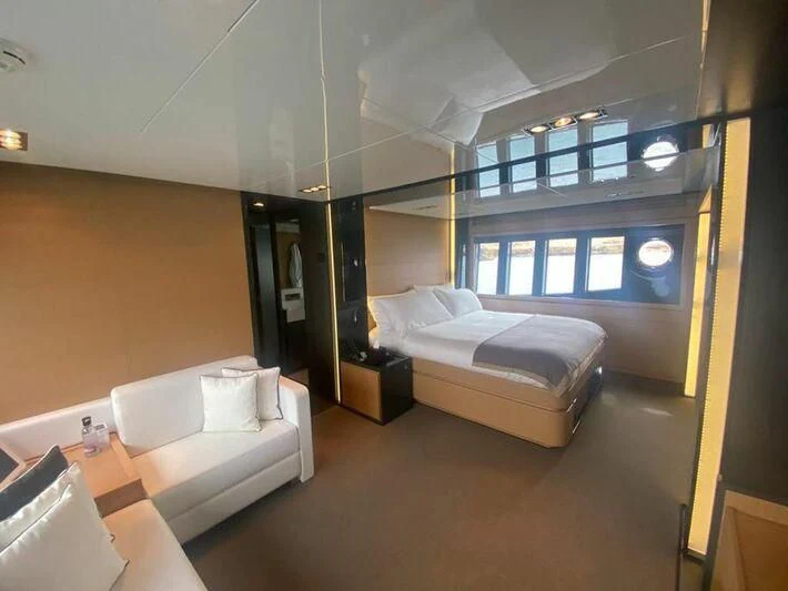 a room with a bed and a couch aboard MY PLACE Yacht for Sale
