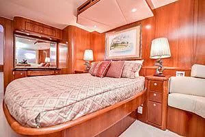 a bedroom with a bed and a mirror aboard CTC Yacht for Sale