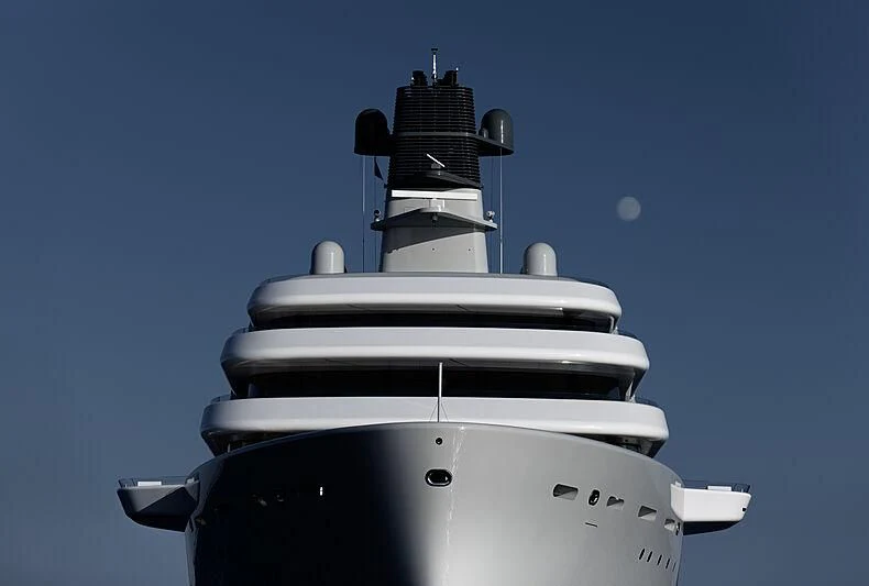 a white and black cylindrical object with a round top and a blue moon in the background aboard SOLARIS Yacht for Sale
