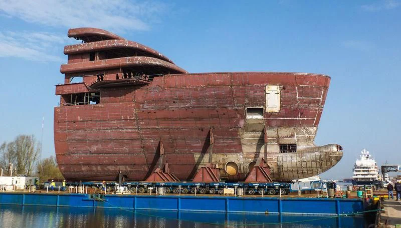 a large red building with a crowd of people around it aboard SOLARIS Yacht for Sale
