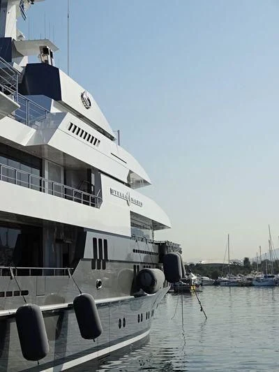 a large white boat in a harbor aboard STELLA MARIS Yacht for Sale