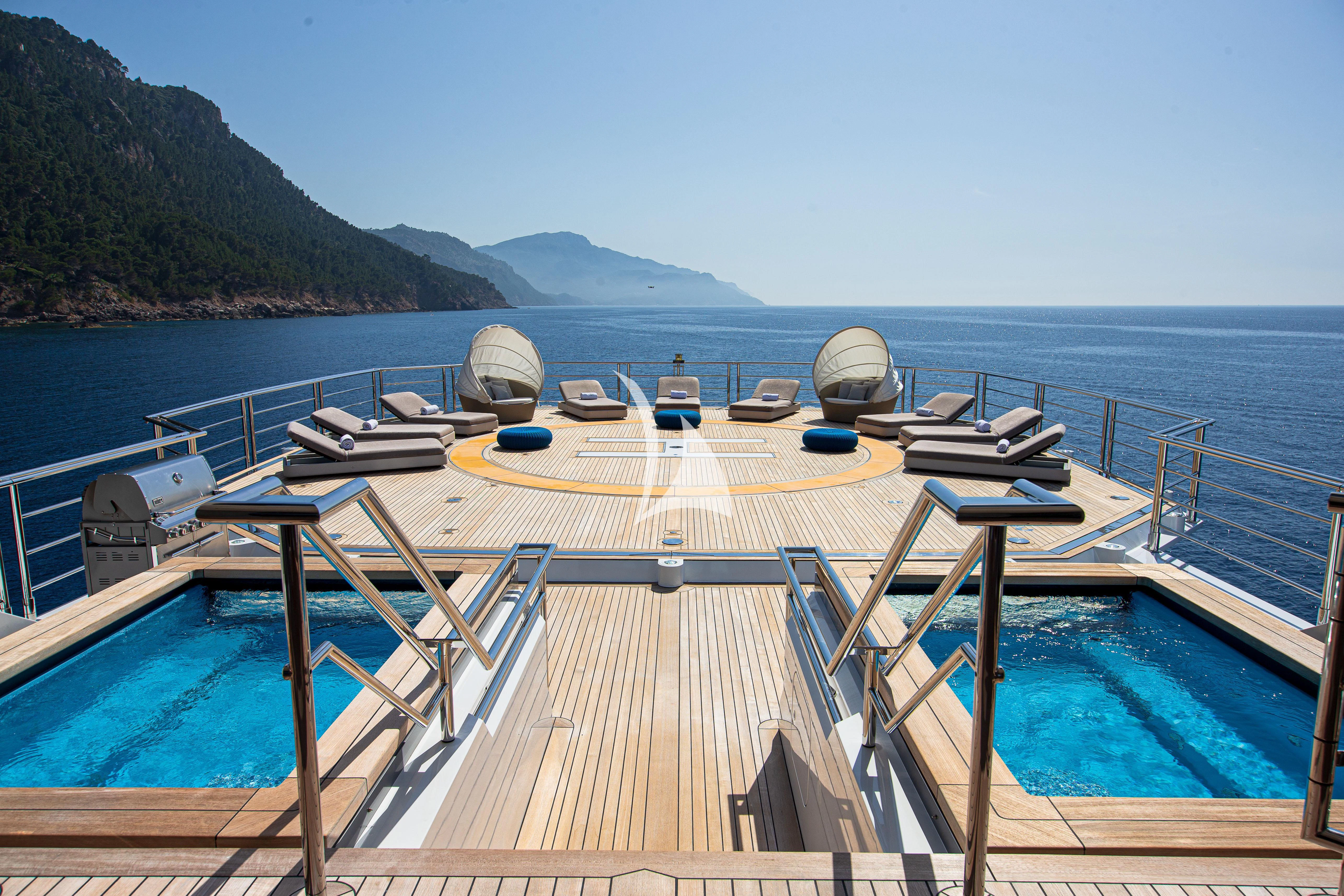 a deck with a dock and boats on it aboard STELLA MARIS Yacht for Sale