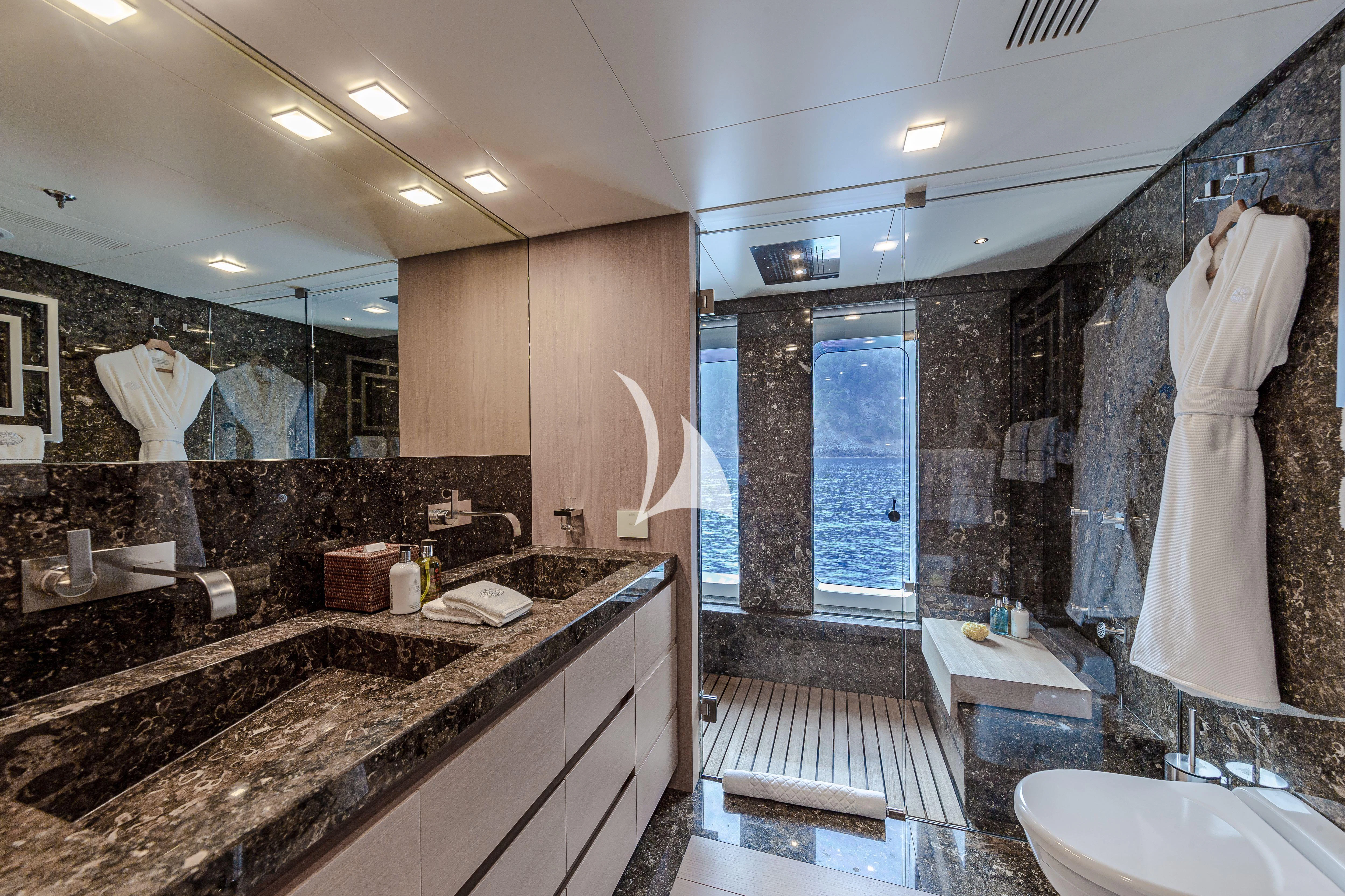 a bathroom with a countertop sink and a large mirror aboard STELLA MARIS Yacht for Sale