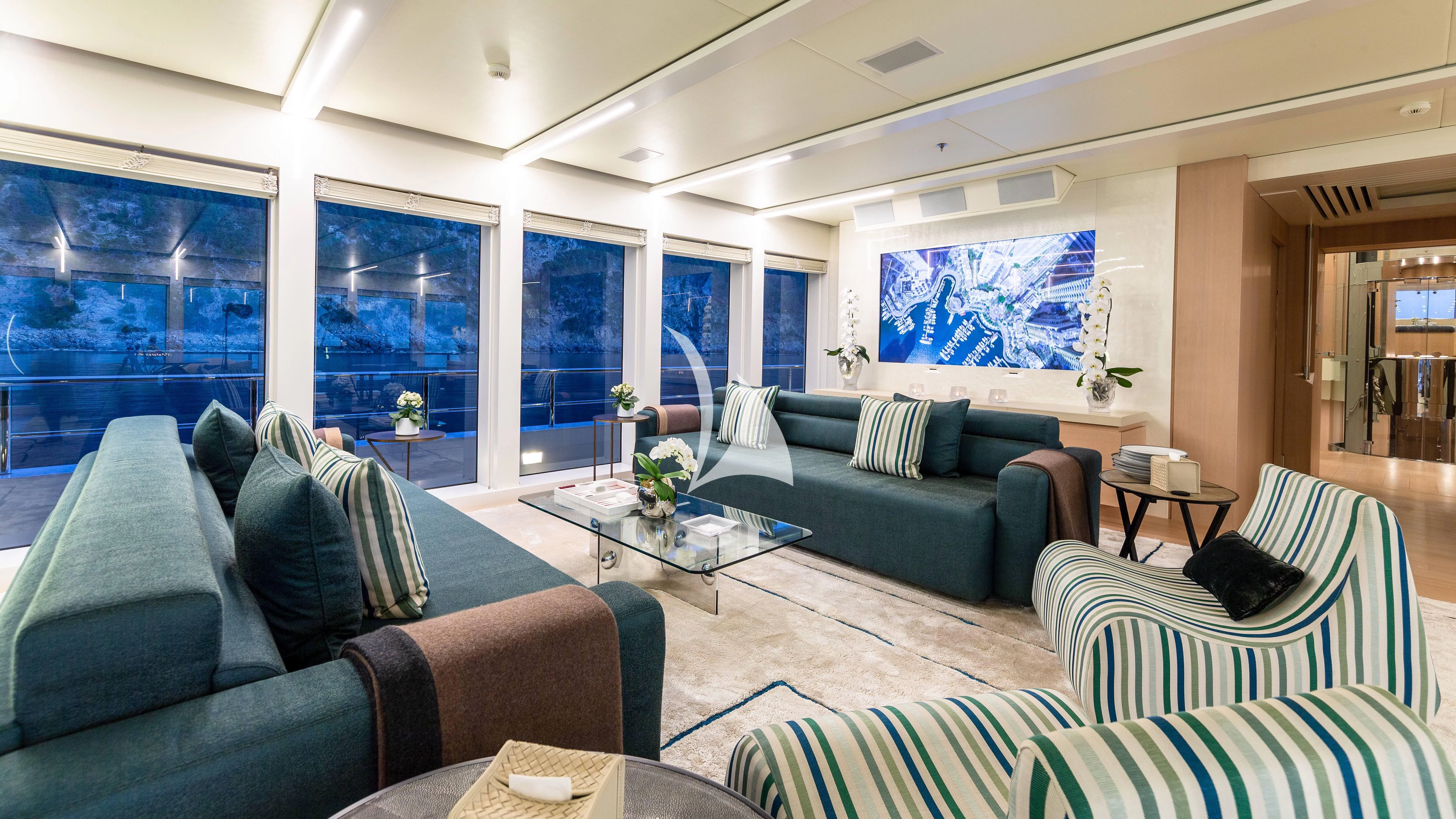 a living room with couches and a coffee table aboard STELLA MARIS Yacht for Sale