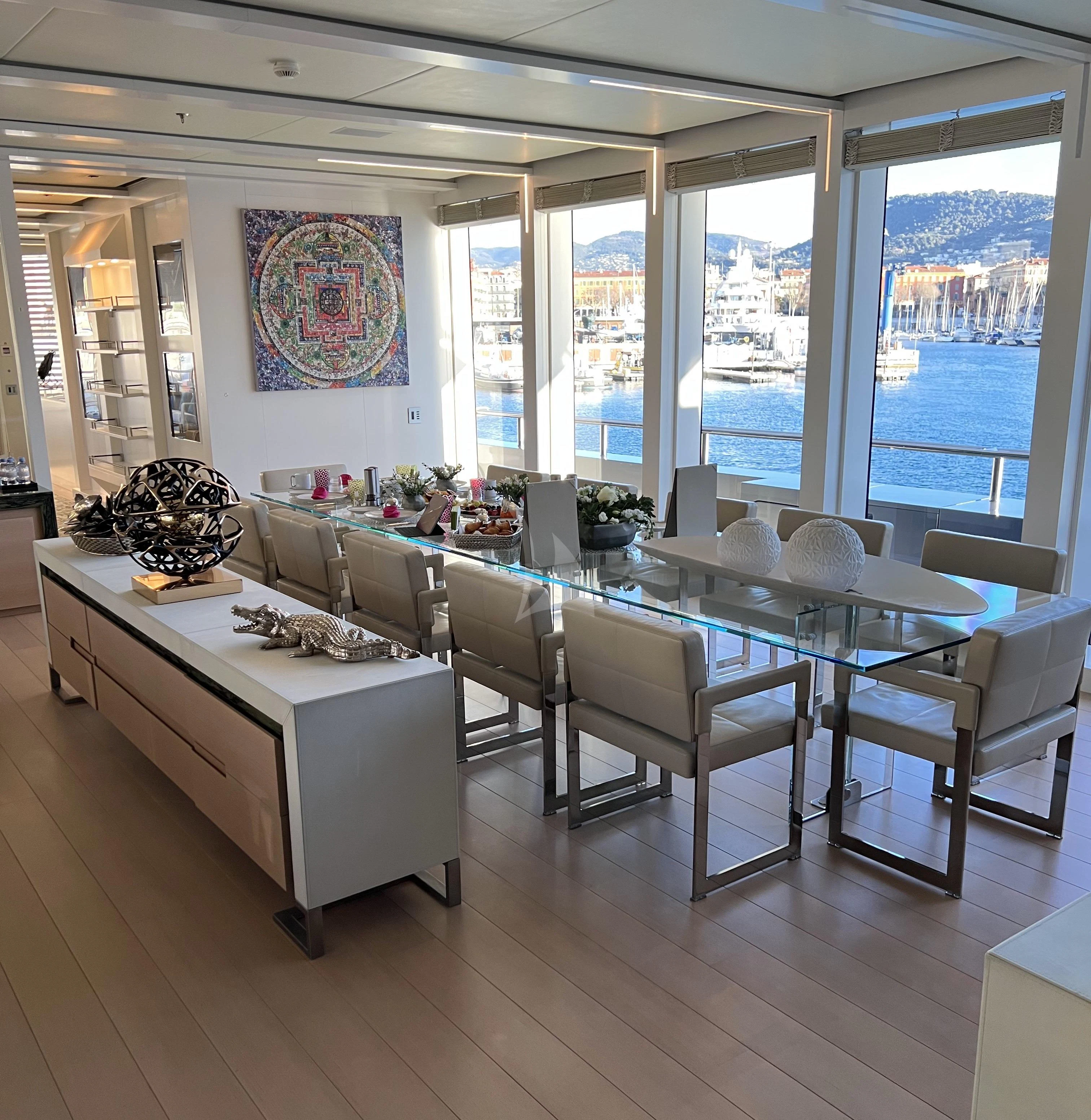 a room with tables and chairs aboard STELLA MARIS Yacht for Sale