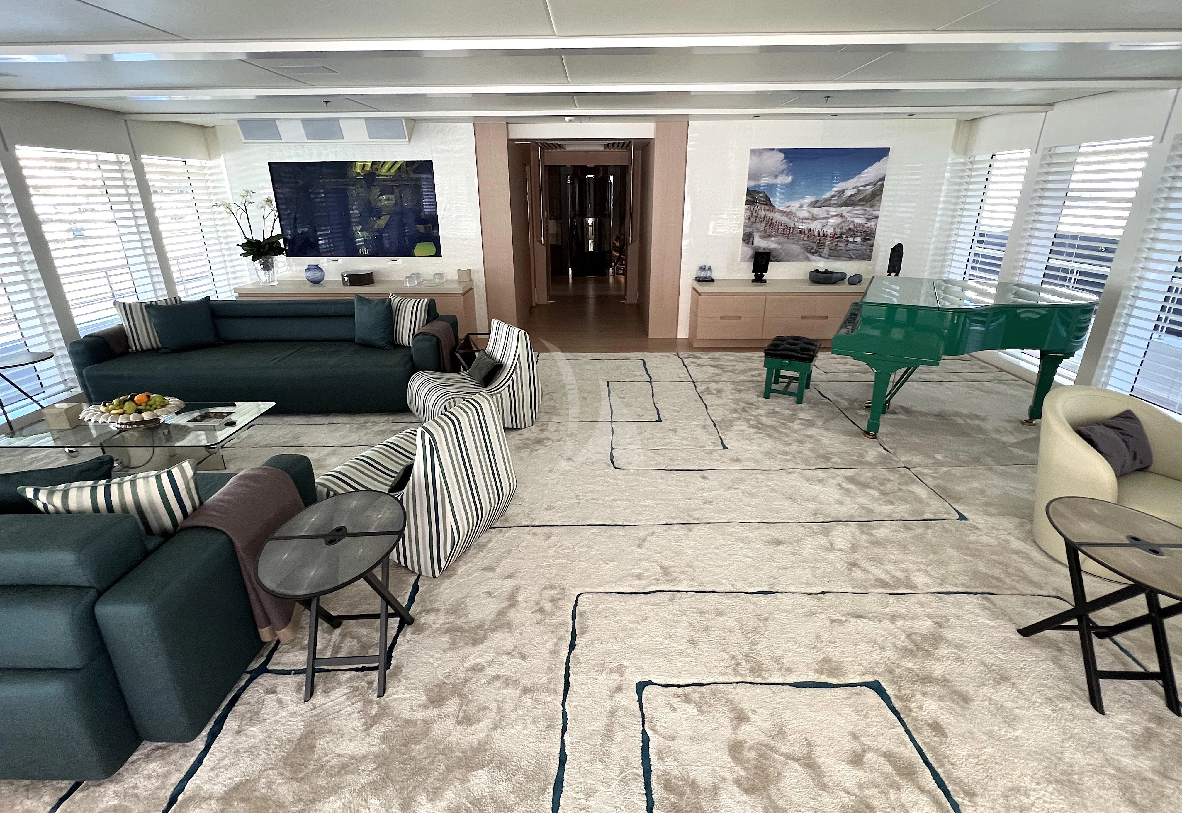 a living room with a couch and a table aboard STELLA MARIS Yacht for Sale