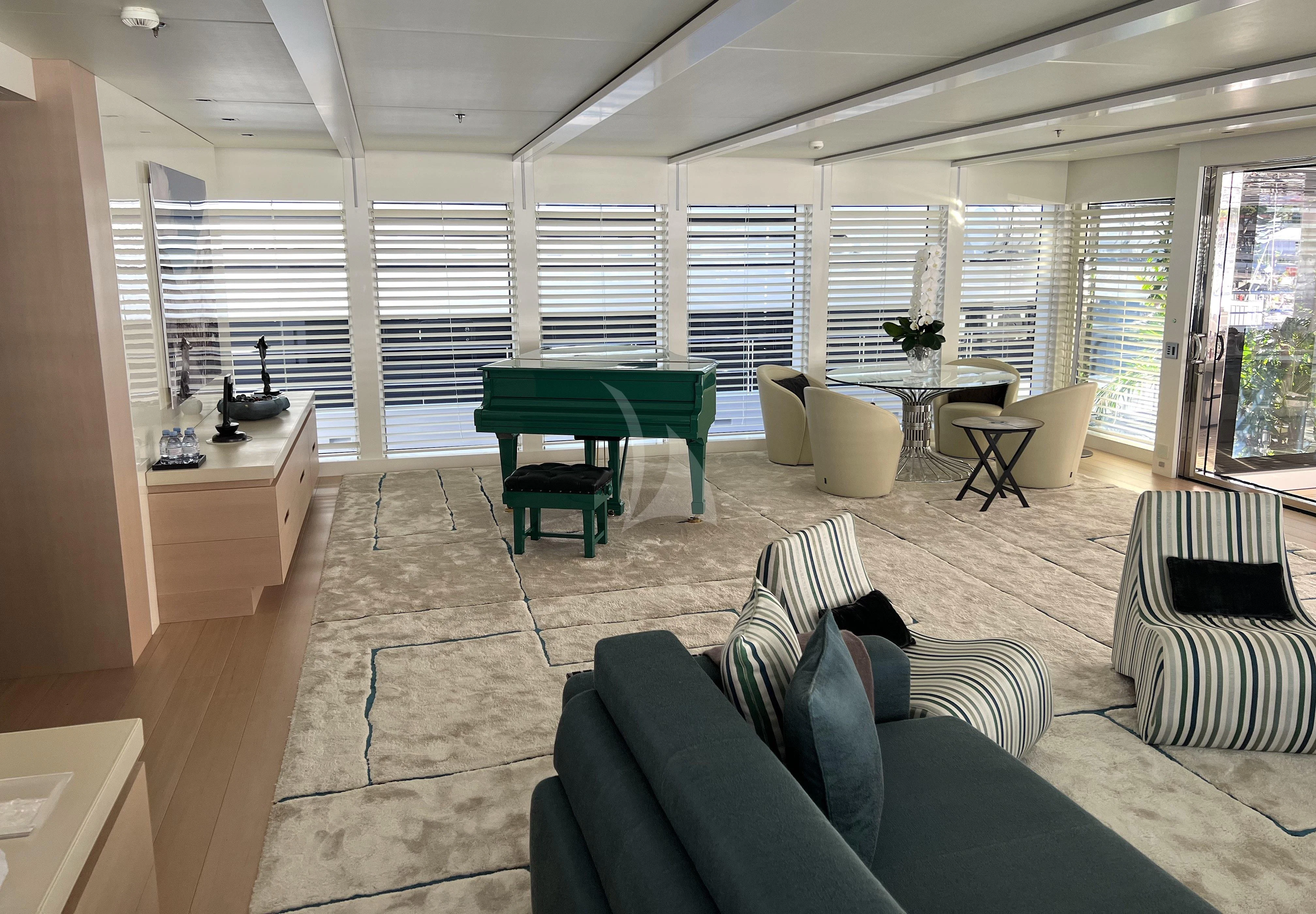 a living room with a couch and a table aboard STELLA MARIS Yacht for Sale