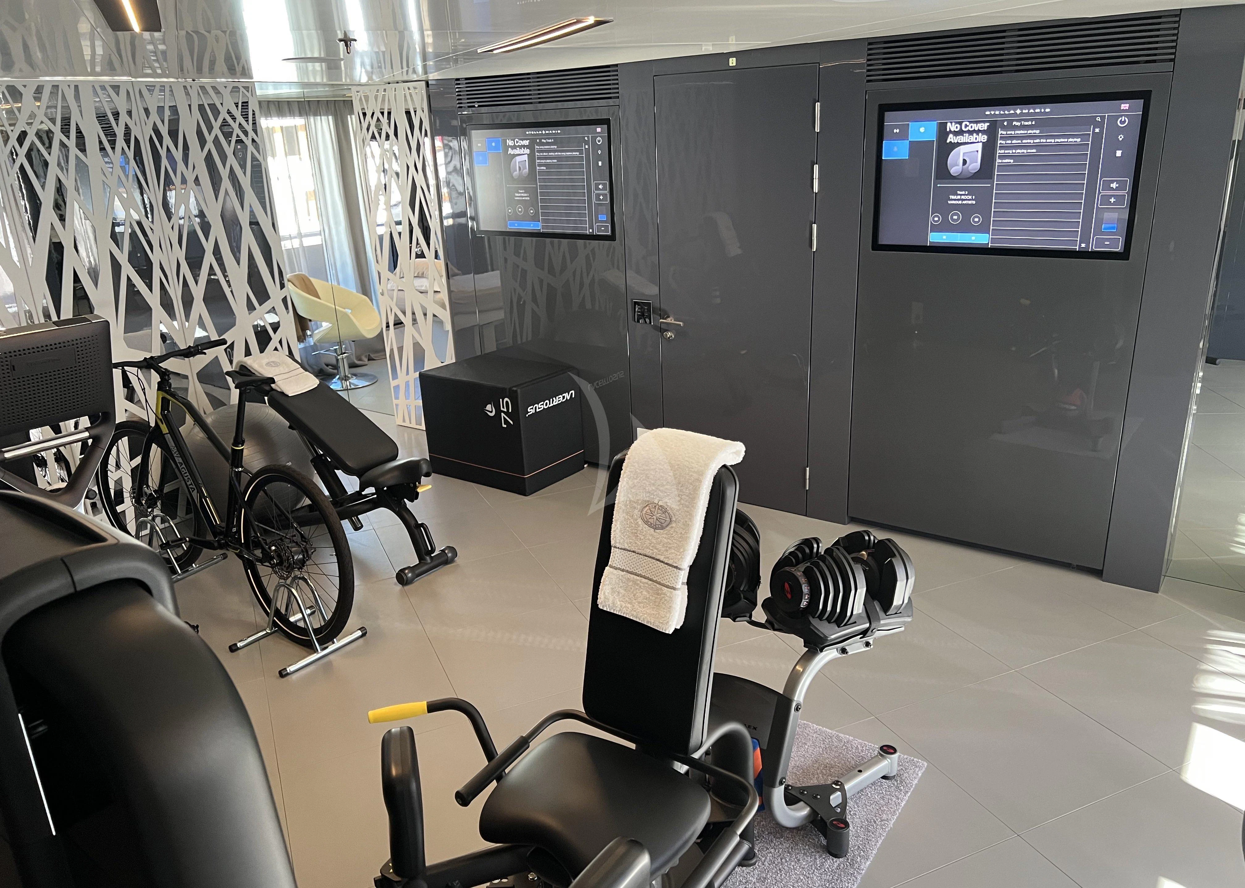 a room with a bike and a machine aboard STELLA MARIS Yacht for Sale