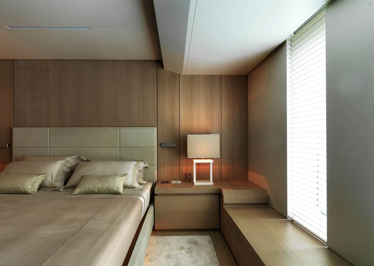 a room with a bed and a lamp aboard STELLA MARIS Yacht for Sale