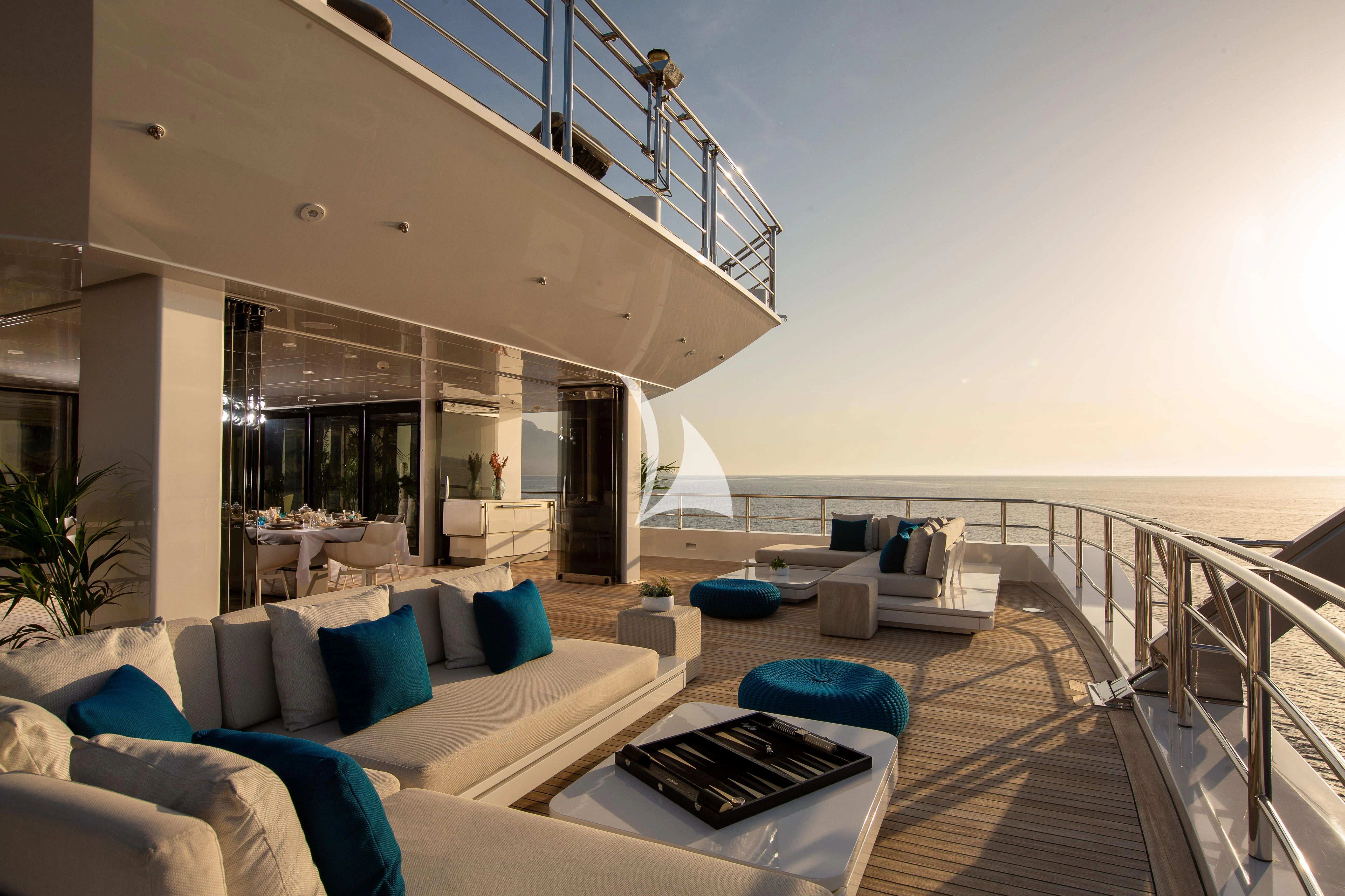 a modern living room with a balcony aboard STELLA MARIS Yacht for Sale