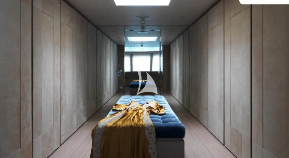 a room with a bed and a chair aboard STELLA MARIS Yacht for Sale