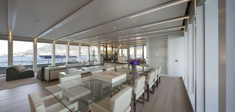 a room with a table chairs and a large window aboard STELLA MARIS Yacht for Sale