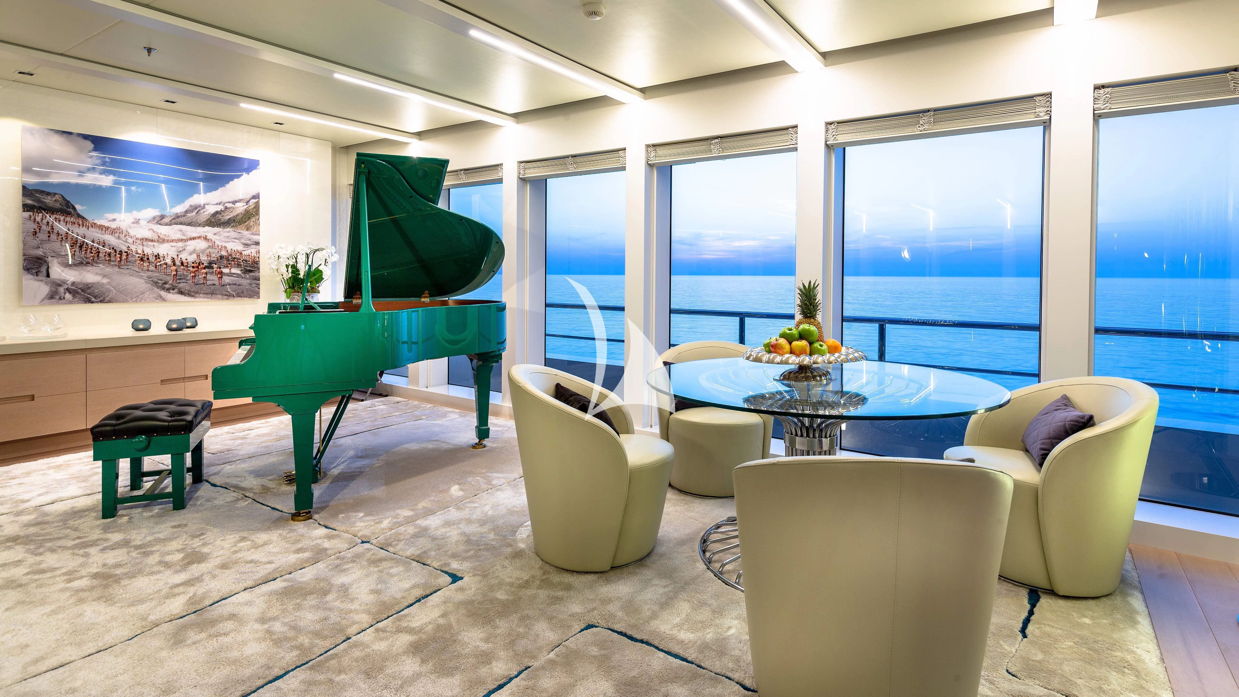 a room with a table chairs and a couch aboard STELLA MARIS Yacht for Sale