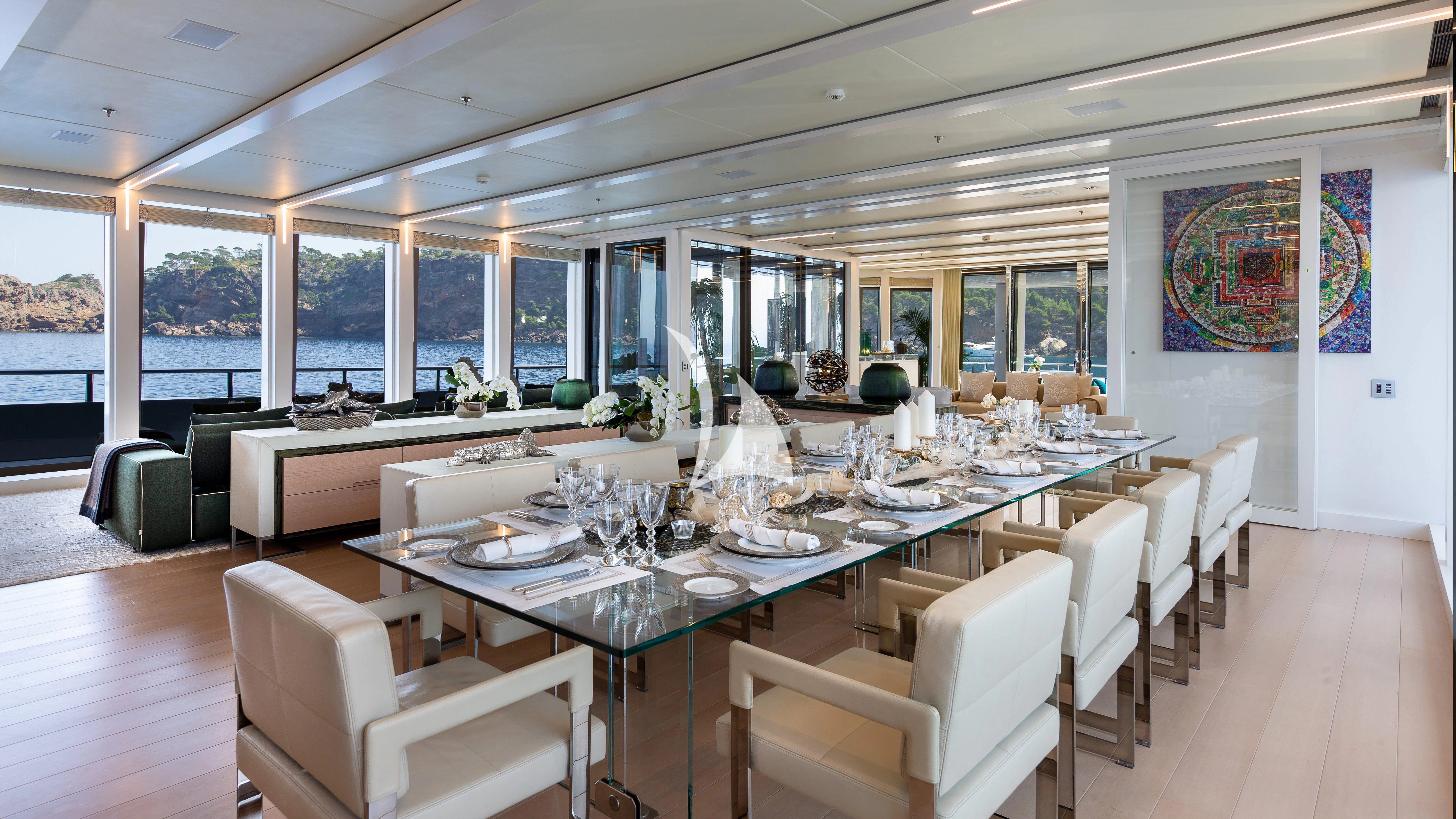 a large dining room with a large table and chairs aboard STELLA MARIS Yacht for Sale