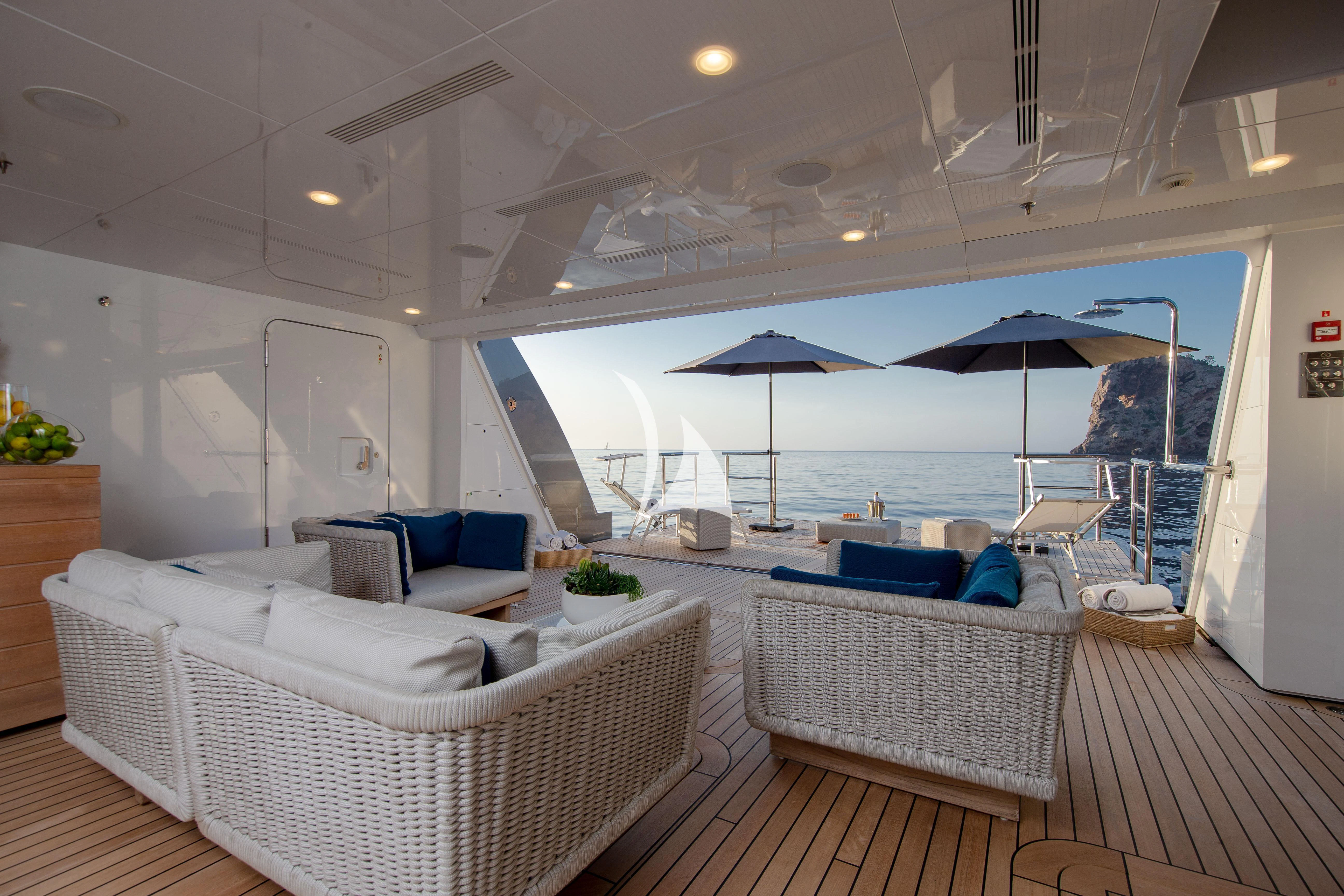 a room with a bed and a couch and a large umbrella aboard STELLA MARIS Yacht for Sale