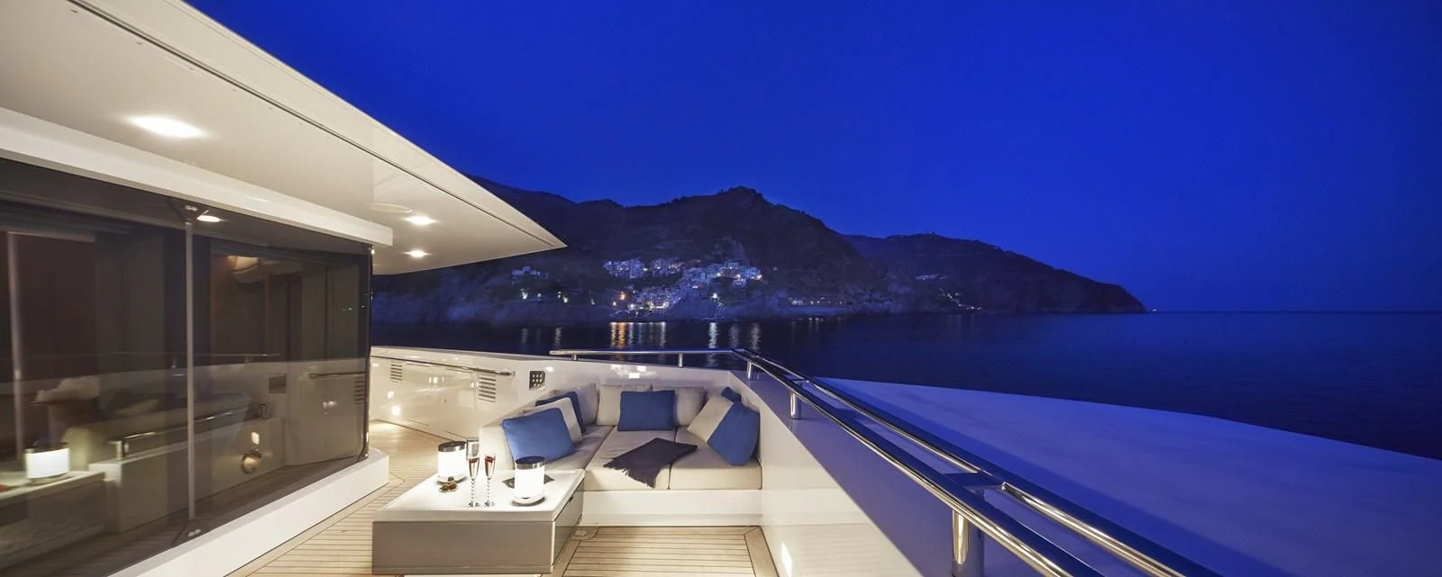 a large white building with a large balcony and a view of the mountains aboard STELLA MARIS Yacht for Sale