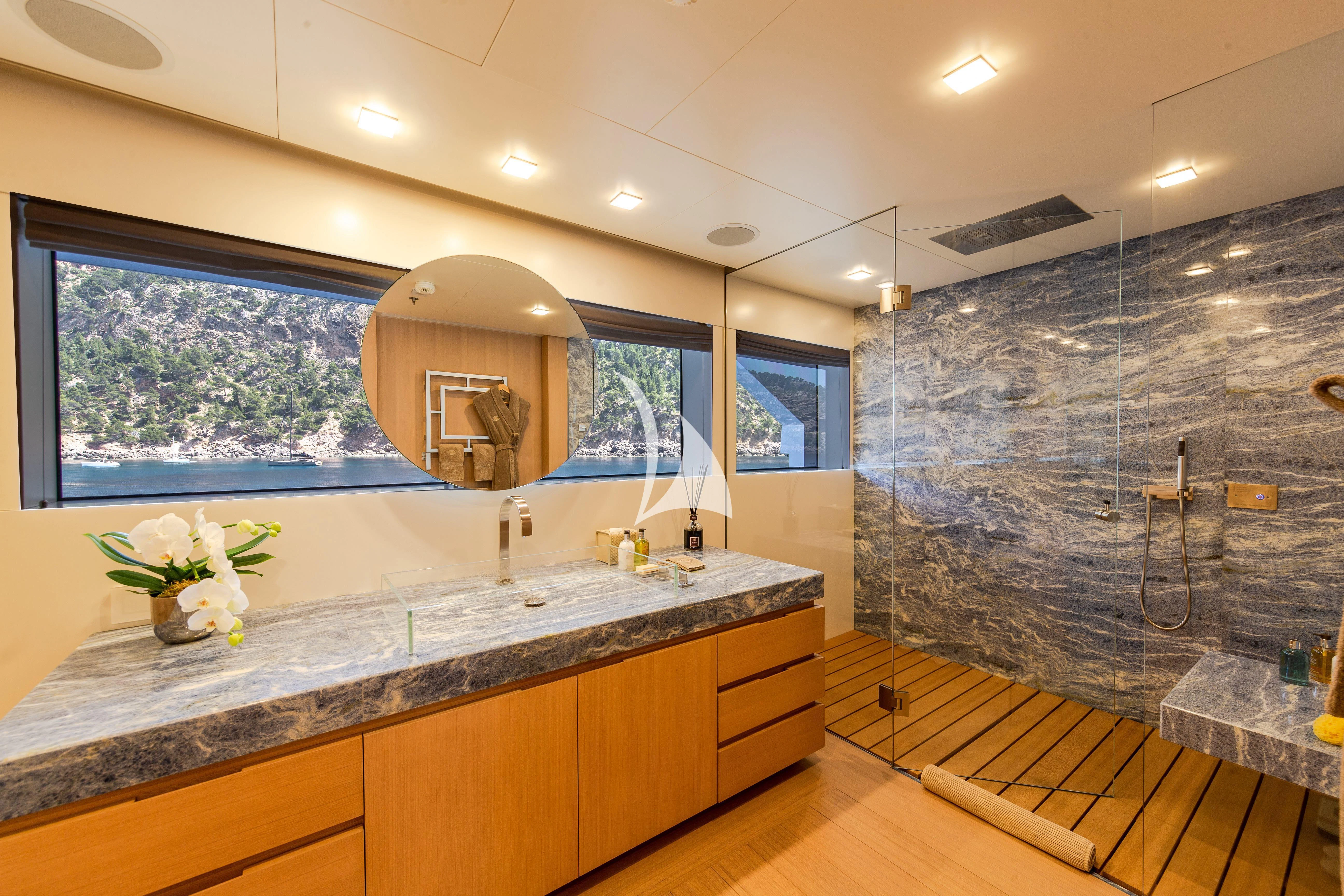 a large bathroom with a large marble countertop aboard STELLA MARIS Yacht for Sale
