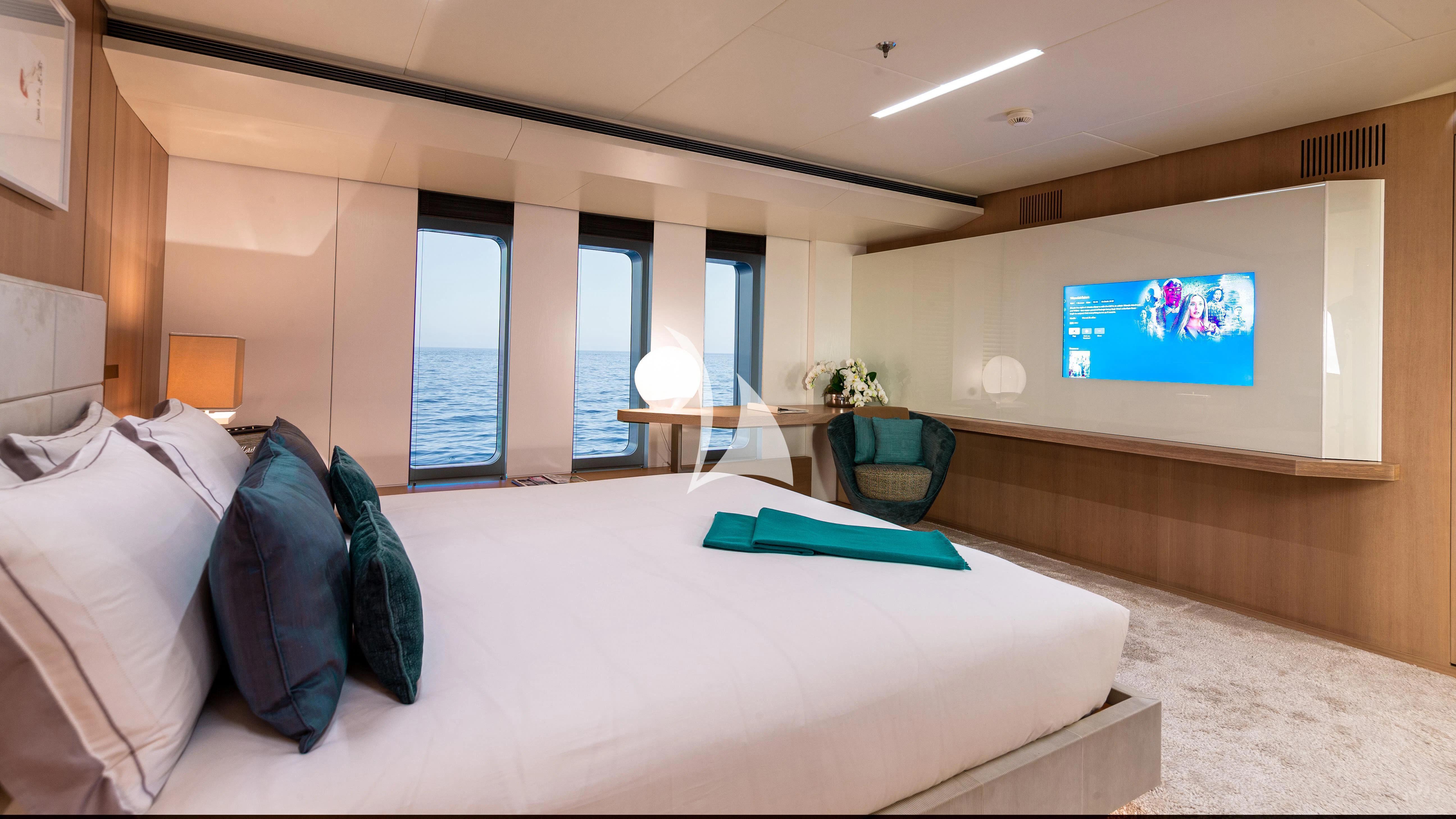 a bed with white sheets and pillows aboard STELLA MARIS Yacht for Sale