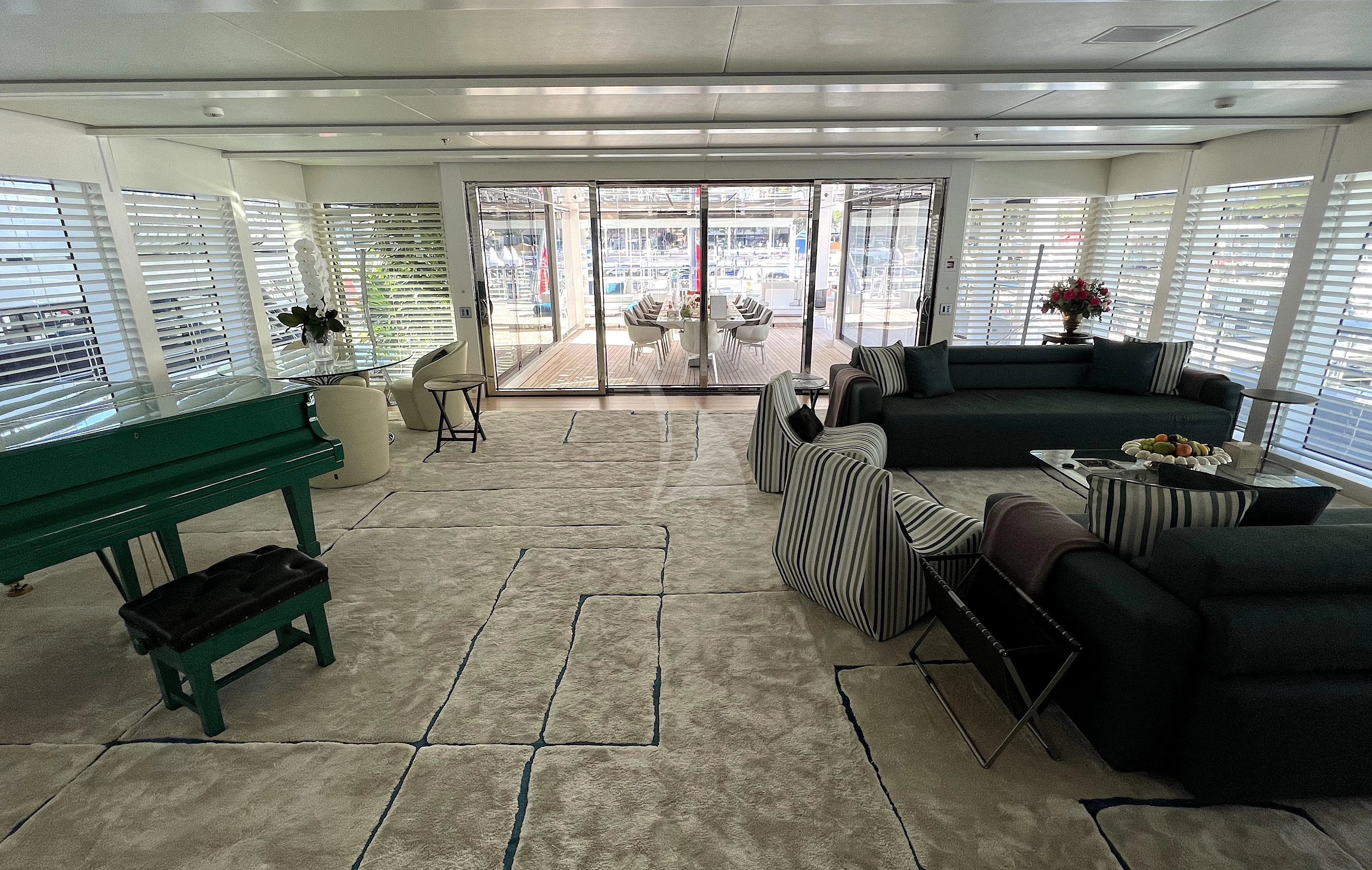 a large room with couches and tables aboard STELLA MARIS Yacht for Sale