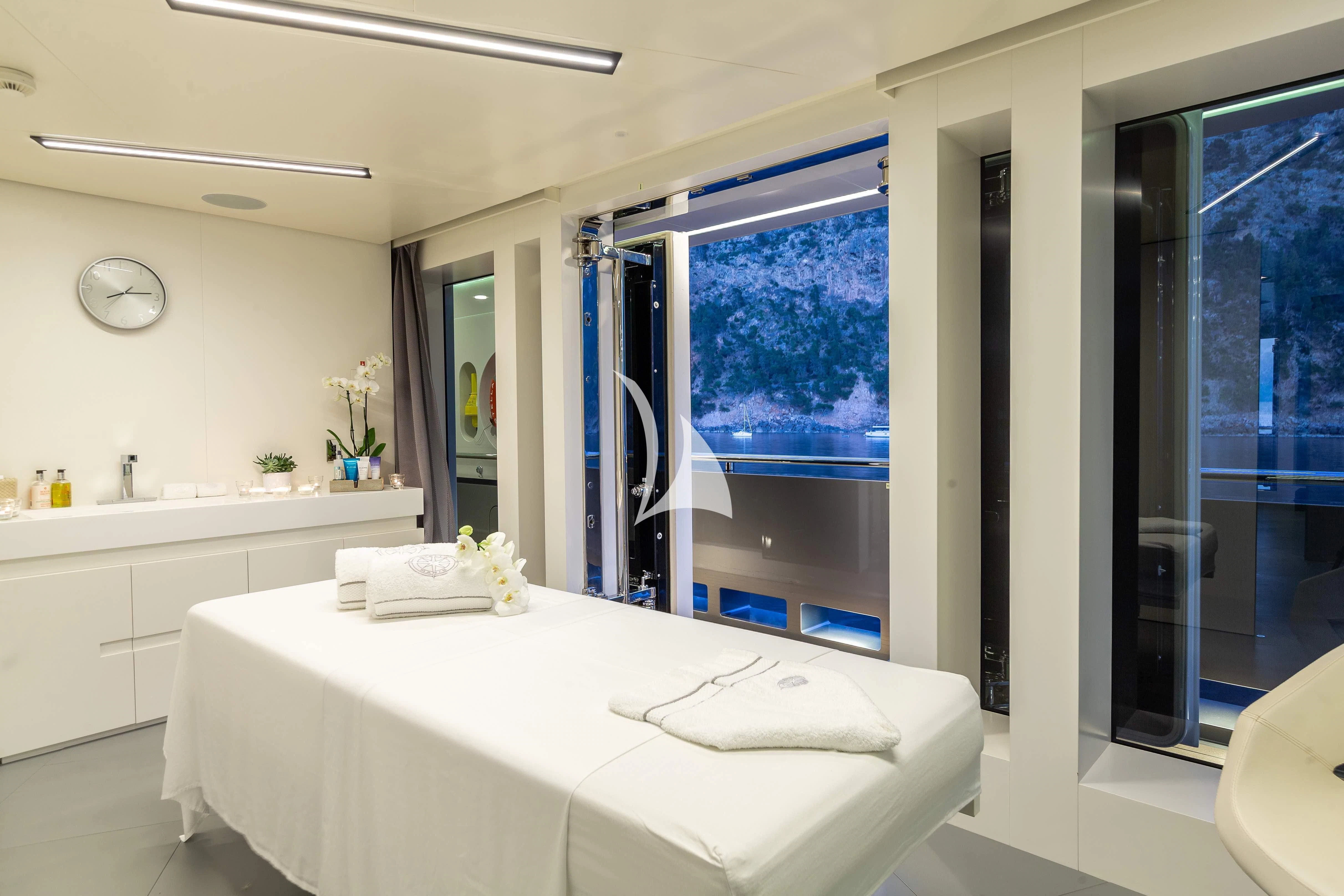 a large white bathroom with a large window aboard STELLA MARIS Yacht for Sale