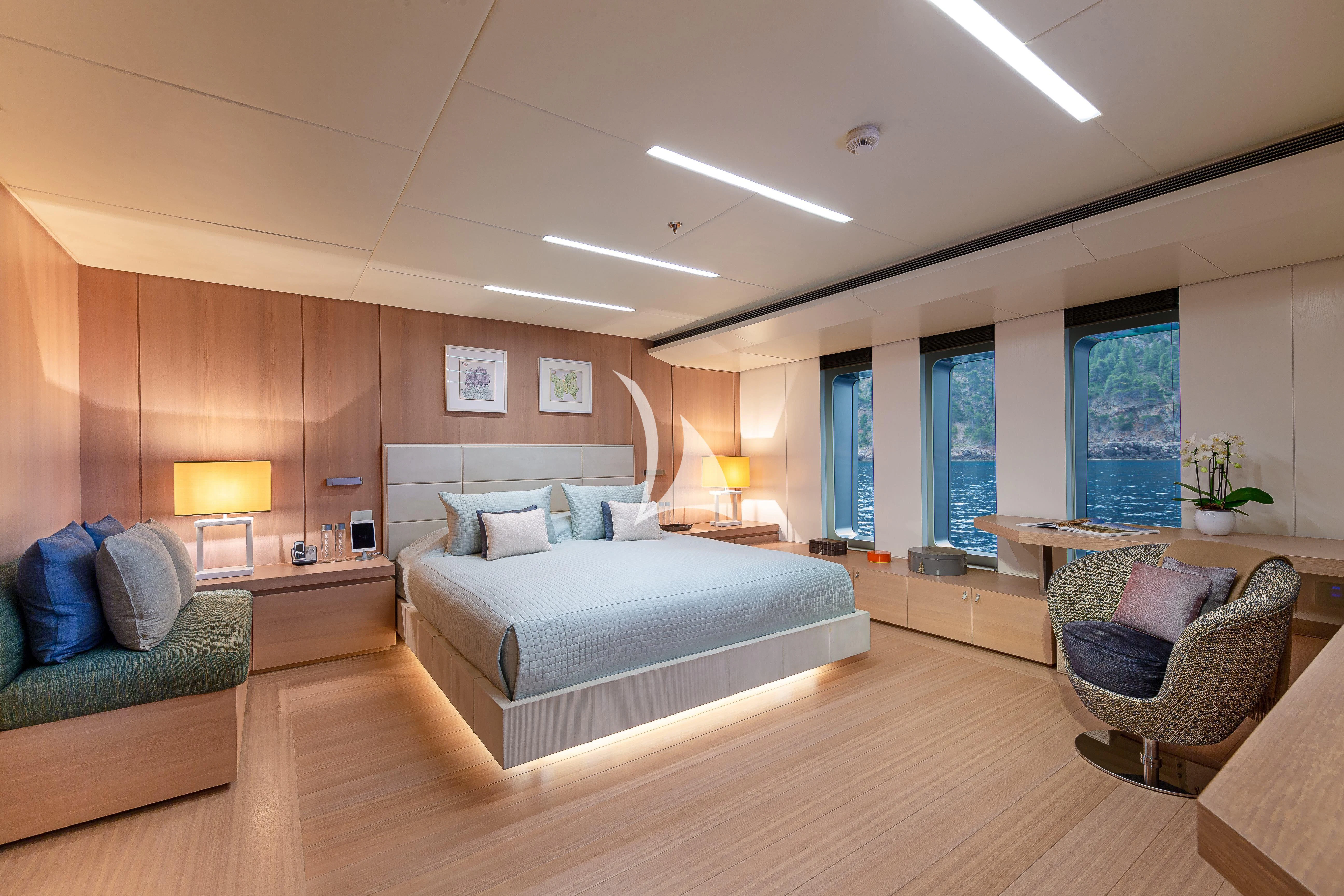 a large bedroom with a bed and a couch aboard STELLA MARIS Yacht for Sale