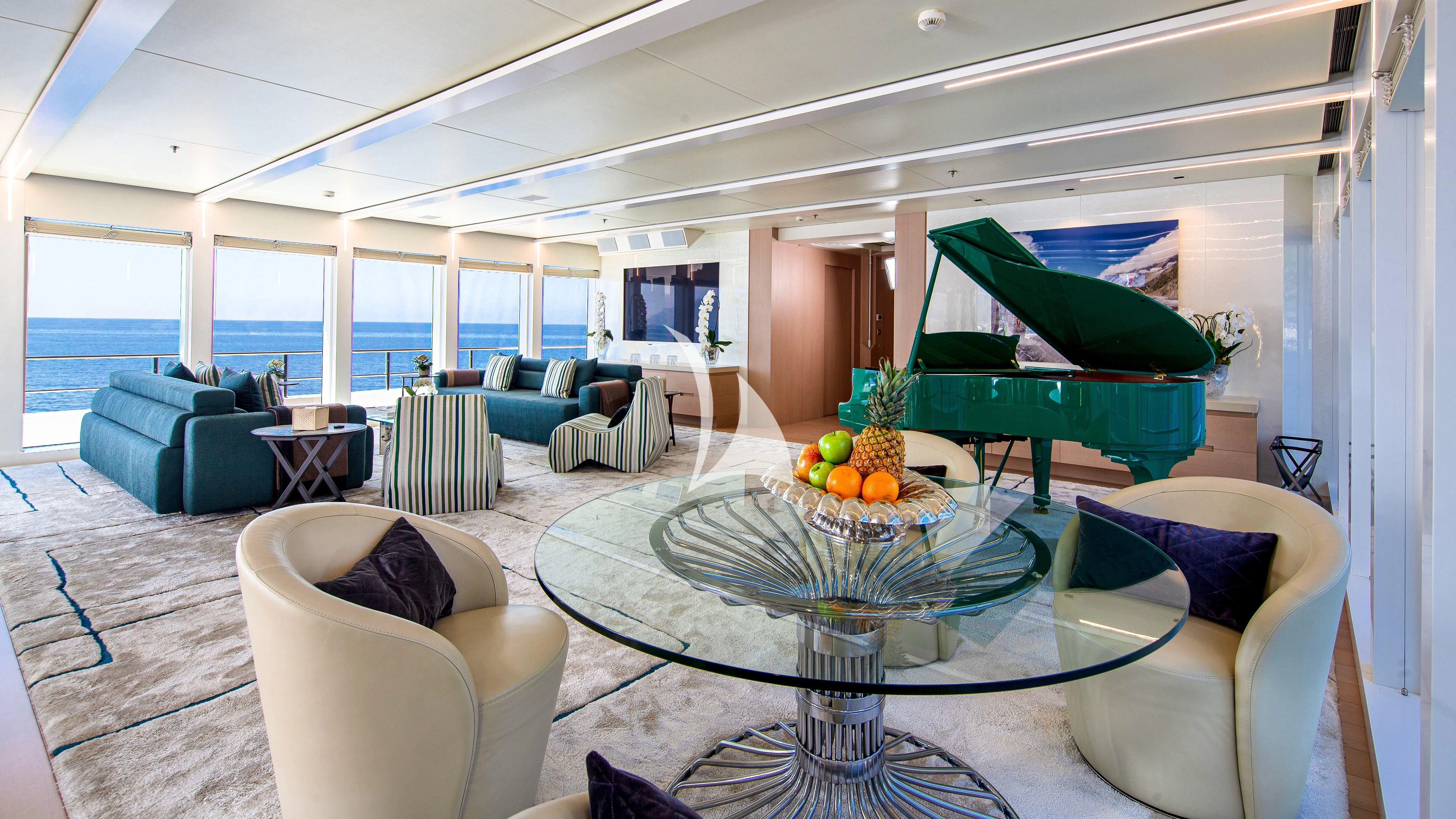 a large living room with a large table and chairs aboard STELLA MARIS Yacht for Sale