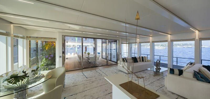 a living room with a large glass door aboard STELLA MARIS Yacht for Sale