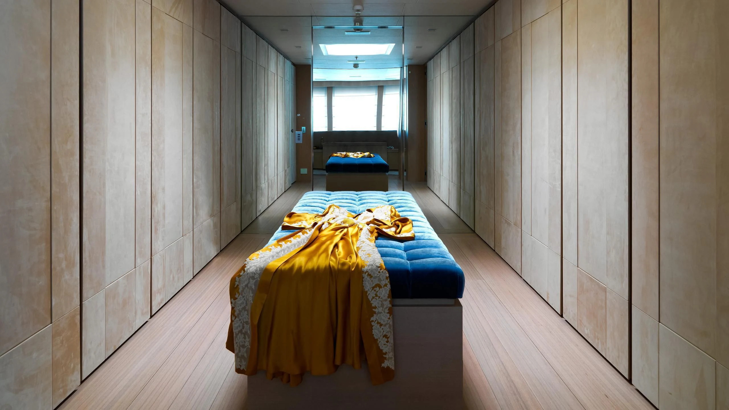 a room with a bed and a blue couch aboard STELLA MARIS Yacht for Sale