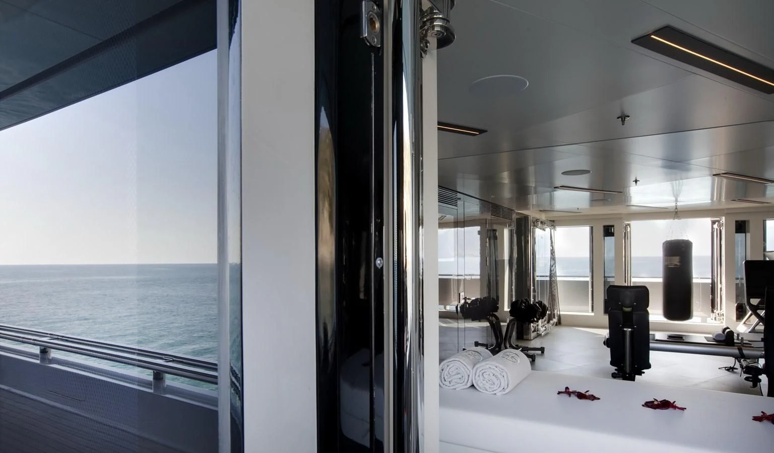 a room with a large mirror and a table with chairs aboard STELLA MARIS Yacht for Sale