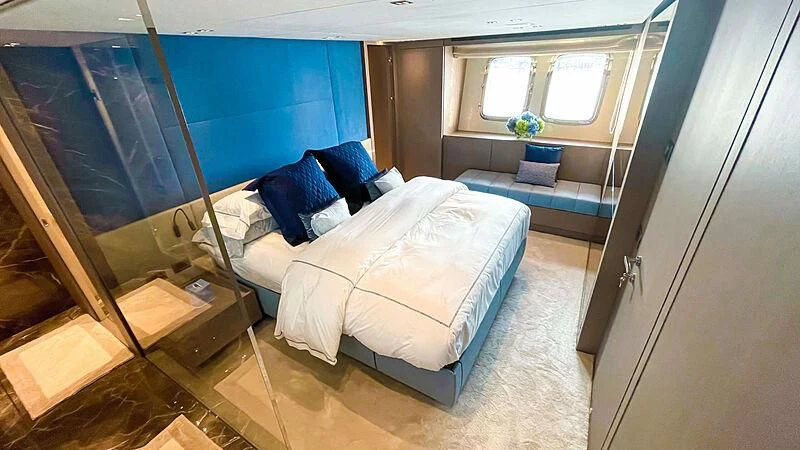 a room with a bed and a window aboard THANOON III Yacht for Sale