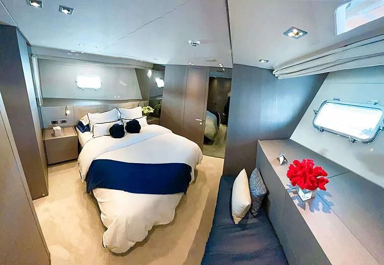 a room with a bed and a table aboard THANOON III Yacht for Sale