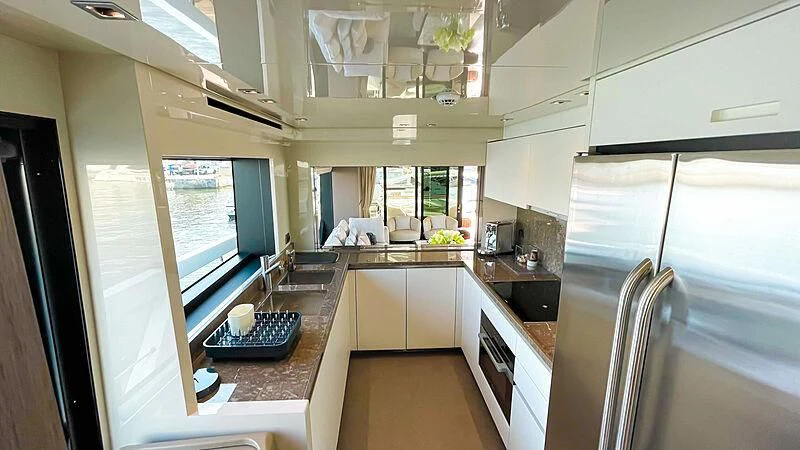 a kitchen with a large window aboard THANOON III Yacht for Sale