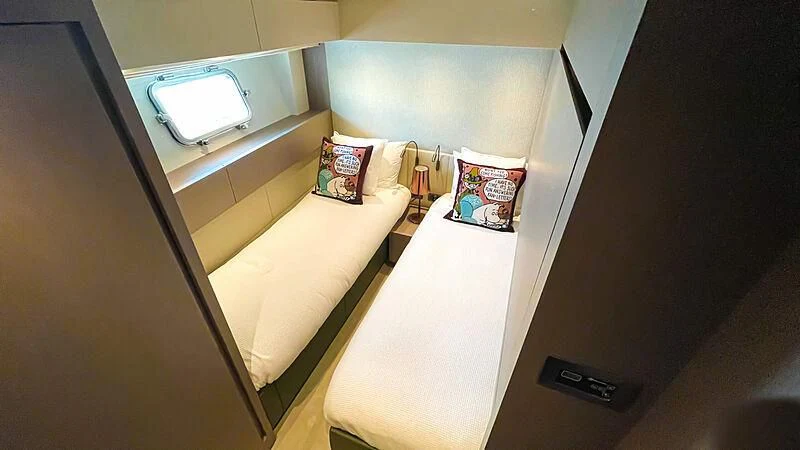 a room with a bed and a mirror aboard THANOON III Yacht for Sale