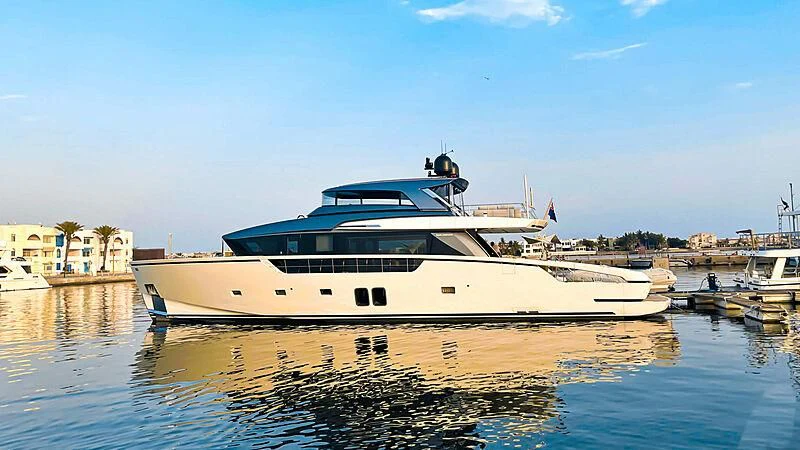 a large white boat in a harbor aboard THANOON III Yacht for Sale